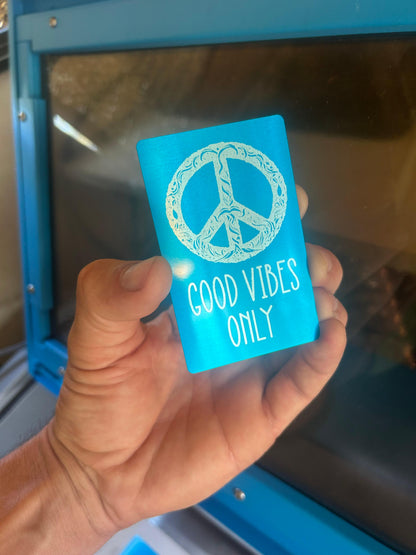 Laser engraved metal Good Vibes Only peace sign design in blue/silver