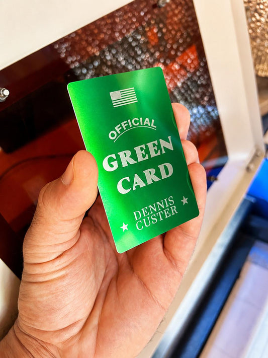 Laser engraved metal green card gag gift layout with personalized name engraving in green/silver anodized aluminum