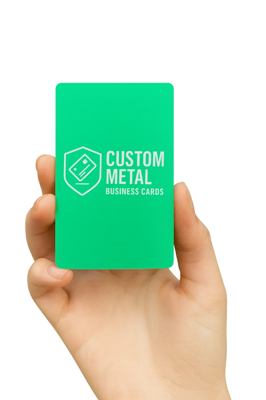 Hand holding a green card with 'Custom Metal Business Cards' text on a white background