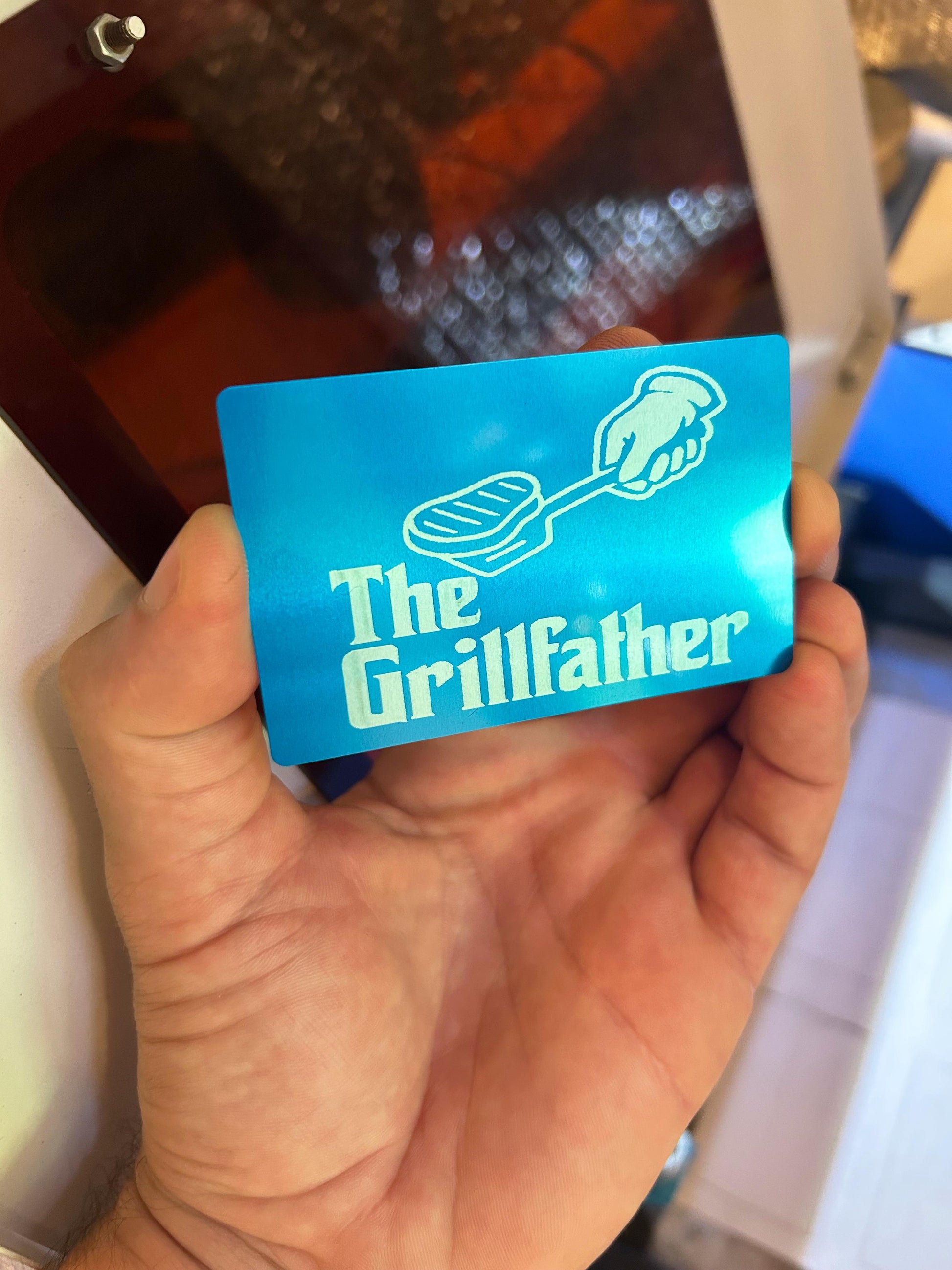 Metal father's day card with The Grillfather graphic in blue/silver