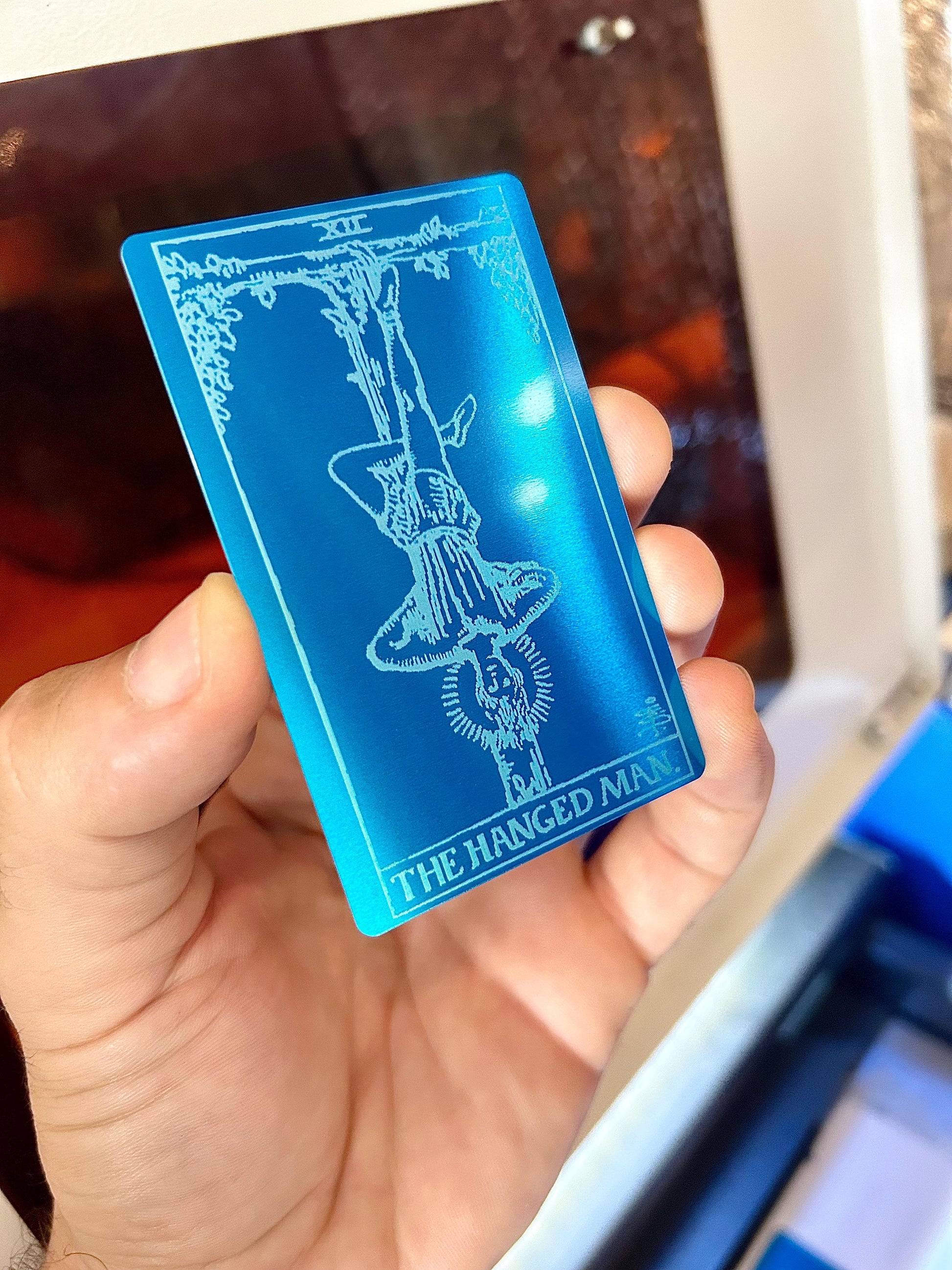 Laser engraved The Hanged Man metal tarot card in blue/silver anodized aluminum