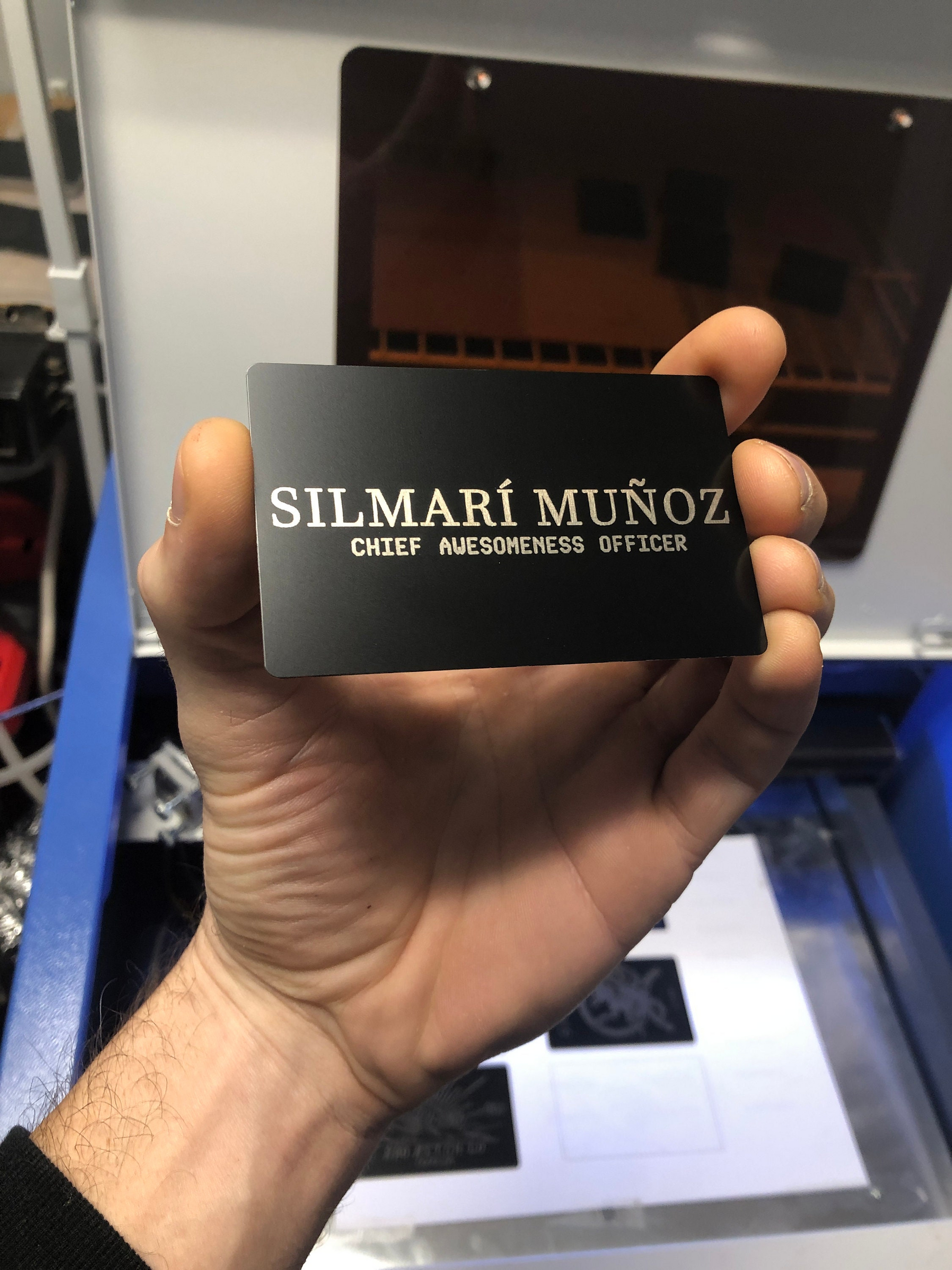Hand holding novelty name plate card with laser engraved name and position with a first and last name