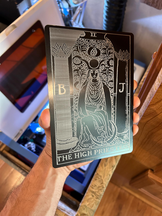 Hand holding a laser engraved 5x7 metal decorative plaque with The High Priestess tarot card engraving in black/silver 