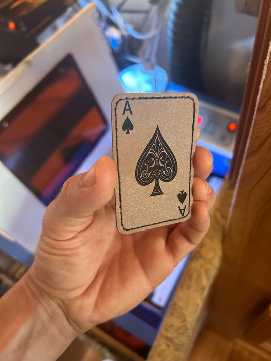hand holding a leather ace of spades laser engraved heat transfer patch size 2x3"