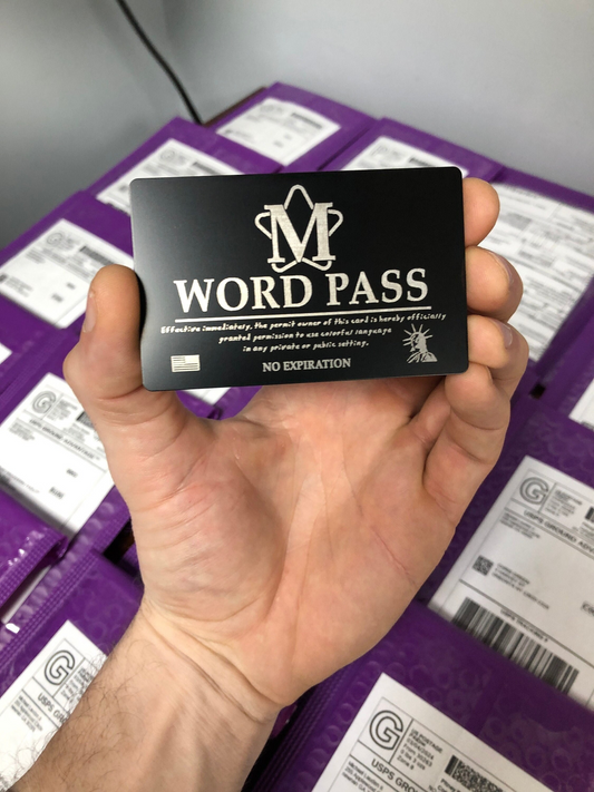 Hand holding a black 'M WORD PASS' metal novelty gag gift card with purple product mailer background