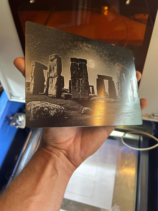Person holding a 5x7 metal plaque with a highly detailed laser engraved image of Stonehenge.