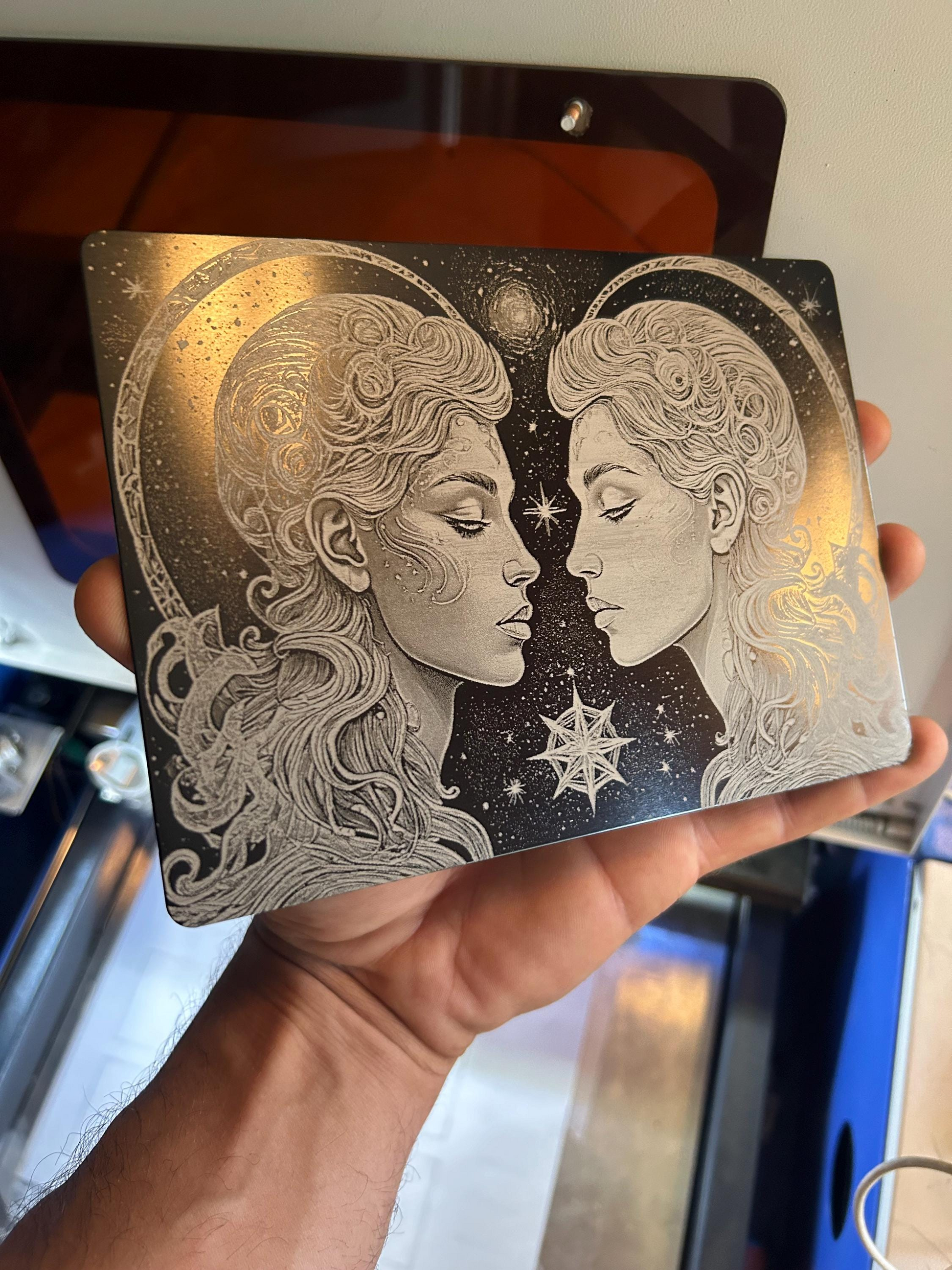 Hand holding a 7x5" metal laser engraved decorative plaque with Gemin Twins psychedelic etching