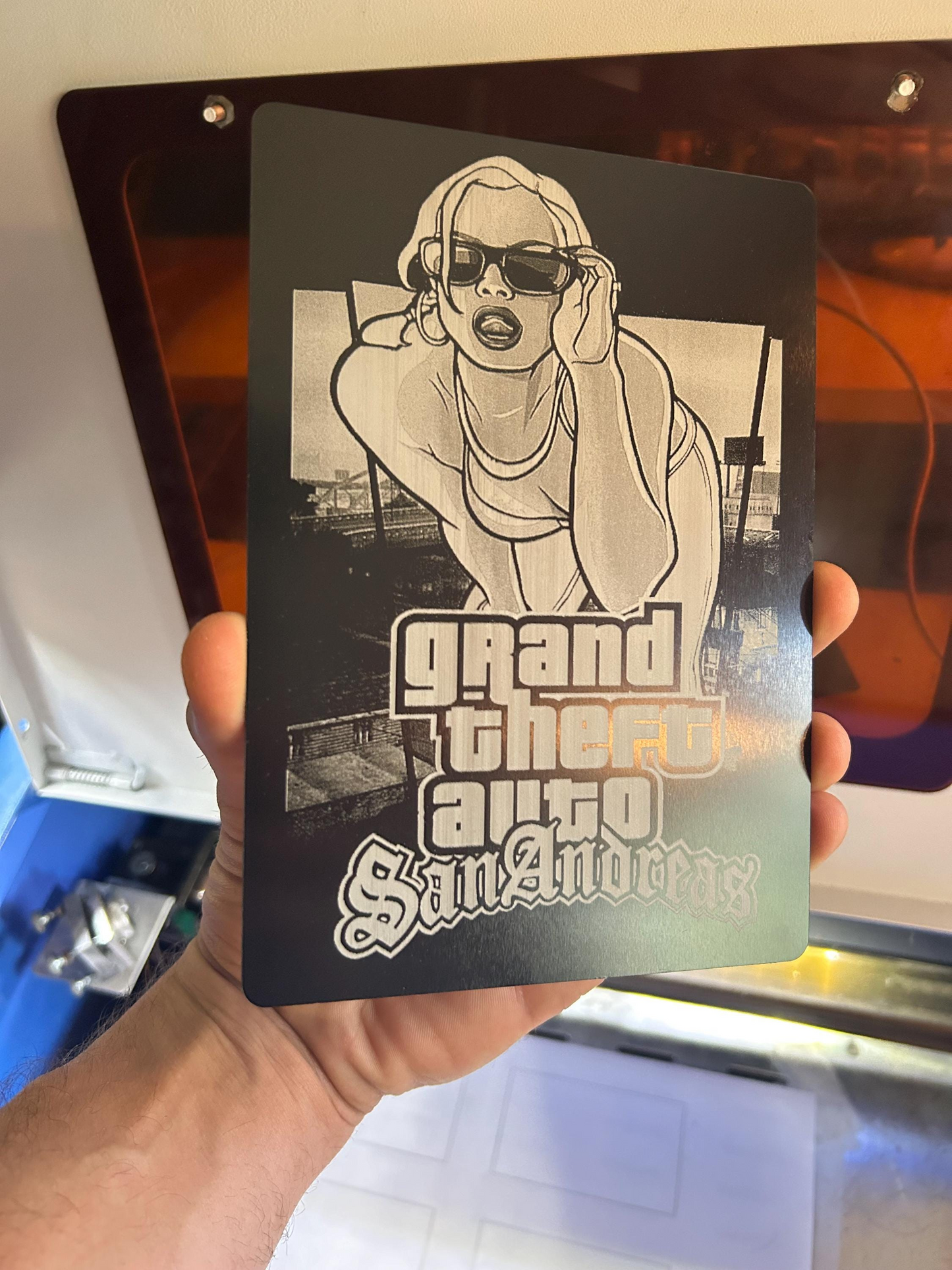 Hand holding laser engraved video game box artwork fan art engraving on 5x7 metal plaque