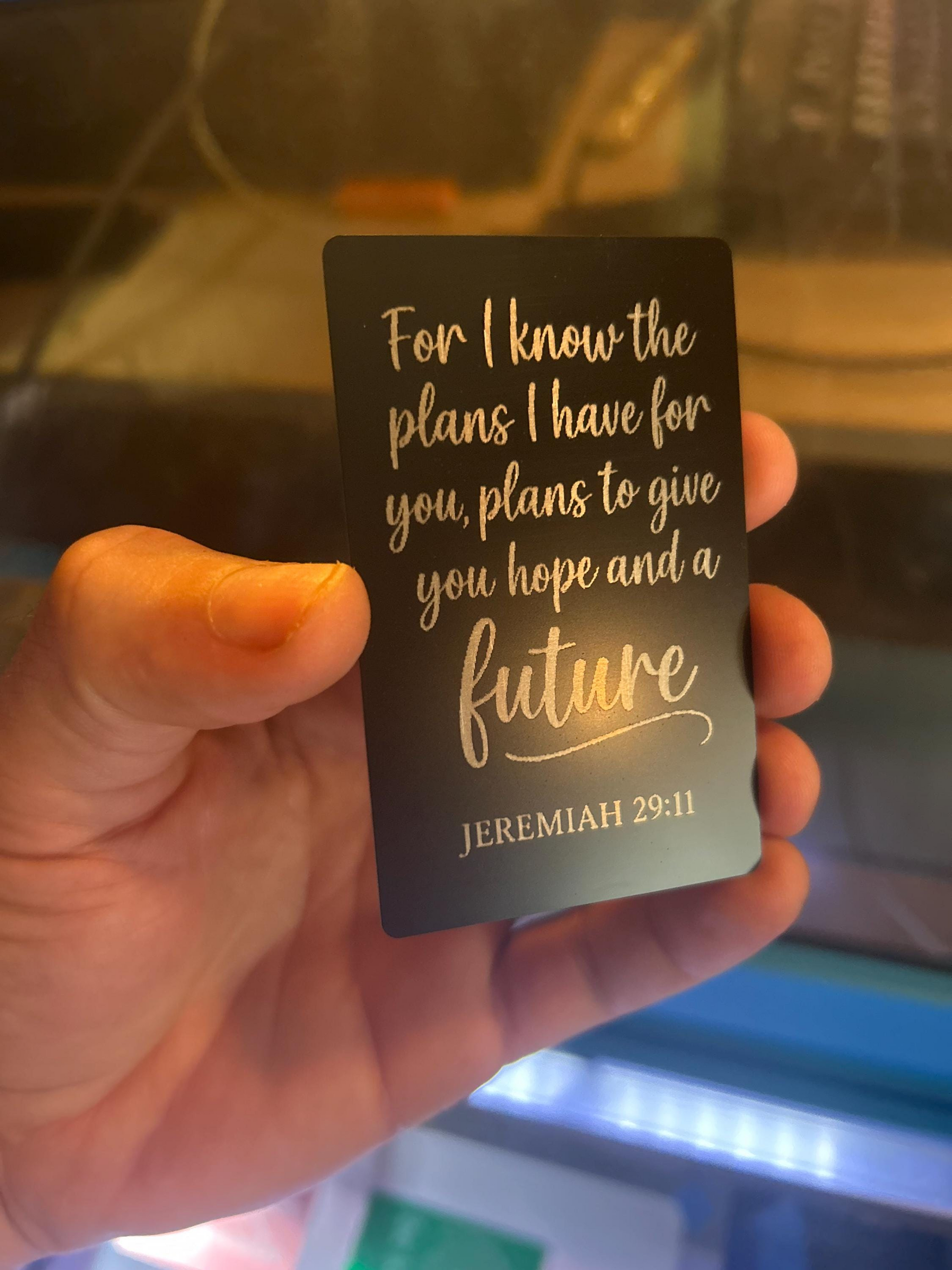 Angled shot of custom black and silver engraved scripture card engraved with Jeremiah 29:11 Bible verse