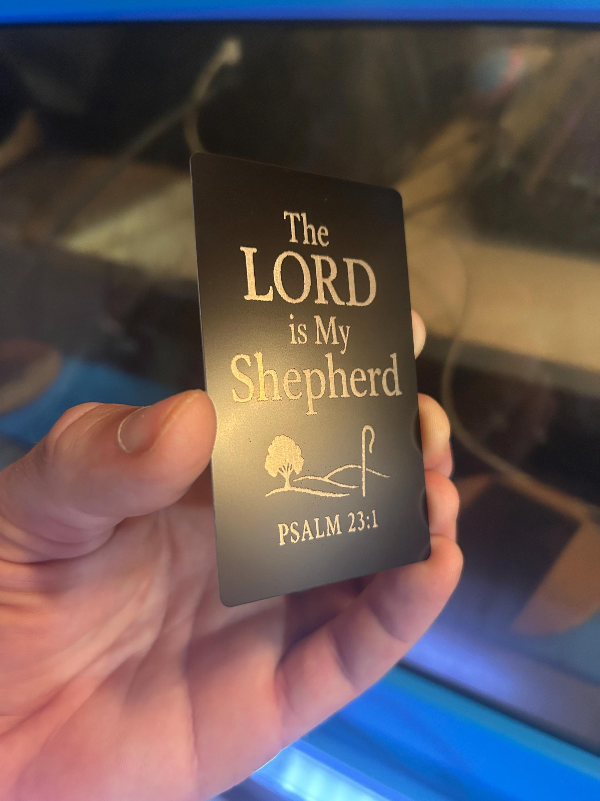 Angled shot of custom laser engraved religious card in black/silver with “The LORD is My Shepherd” text