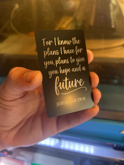 Detailed view of engraved anodized aluminum inspirational card with Jeremiah 29:11 verse in silver on black finish