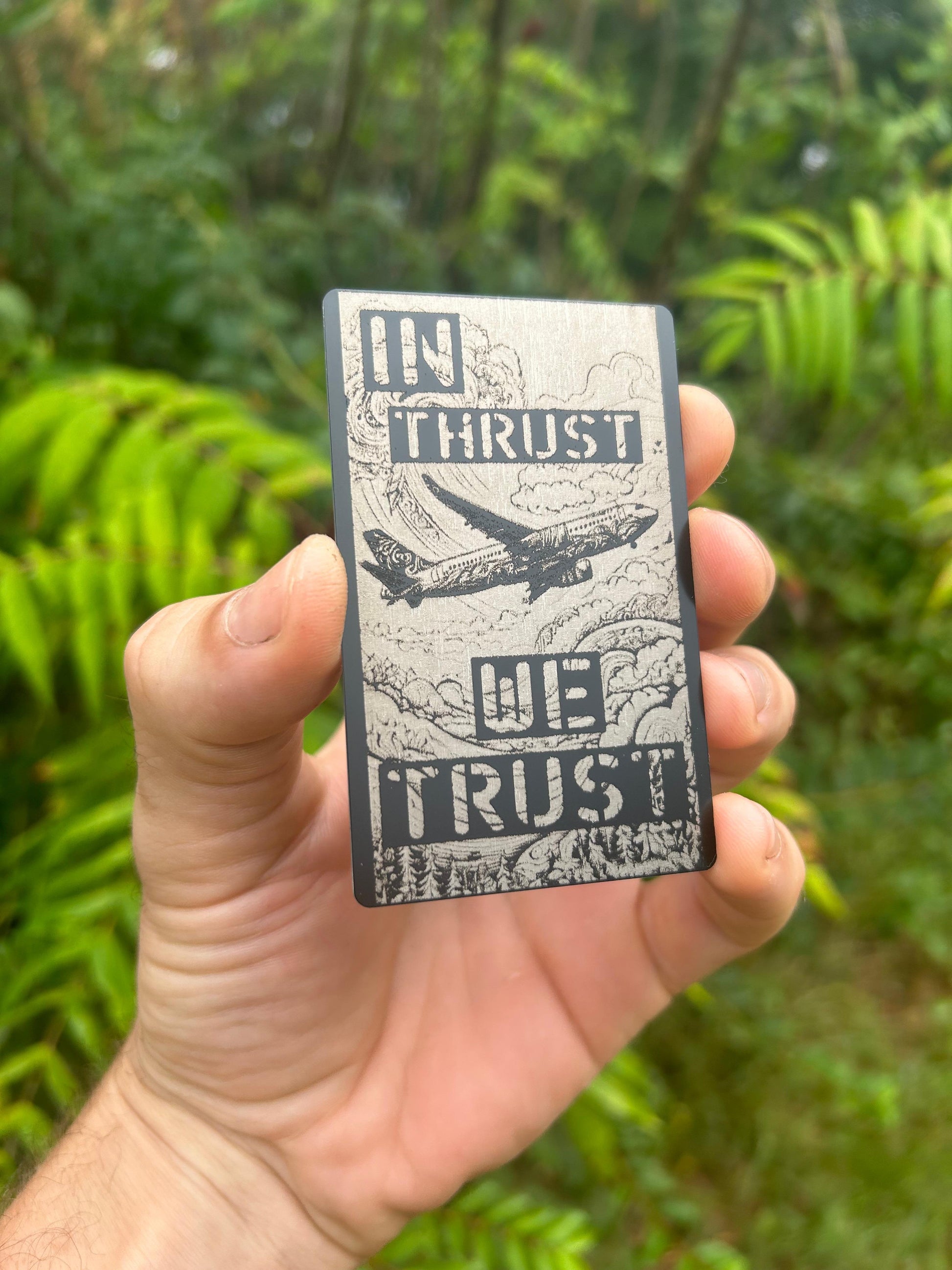 Laser engraved aviation gift with In Thrust We Trust design with jetliner in the clouds in black/silver