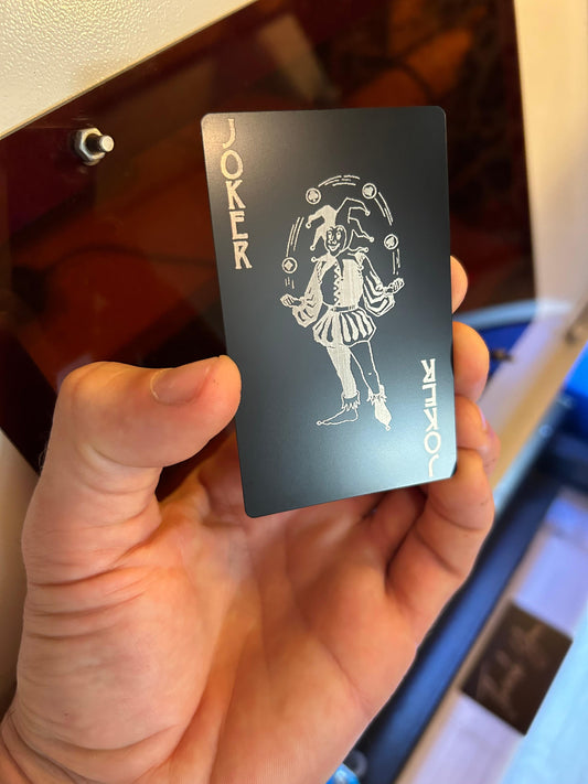 Laser engraved metal joker playing card in black/silver