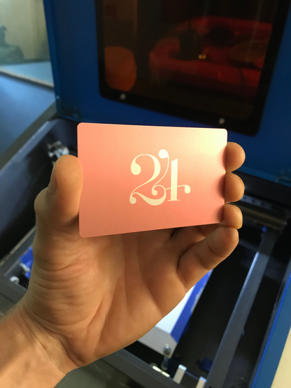 Laser engraved metal business card with personalized art