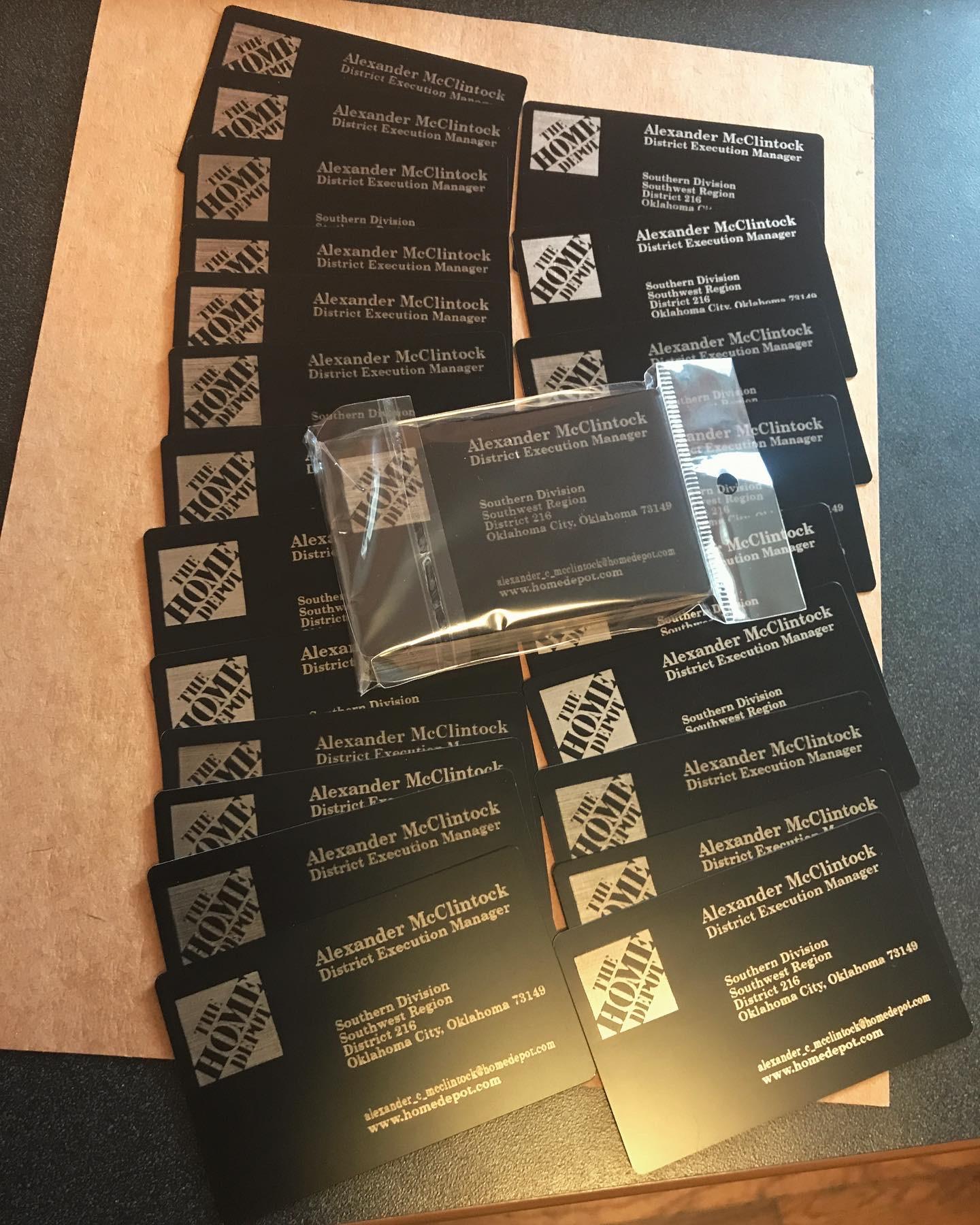Stack of metal business cards with silver text