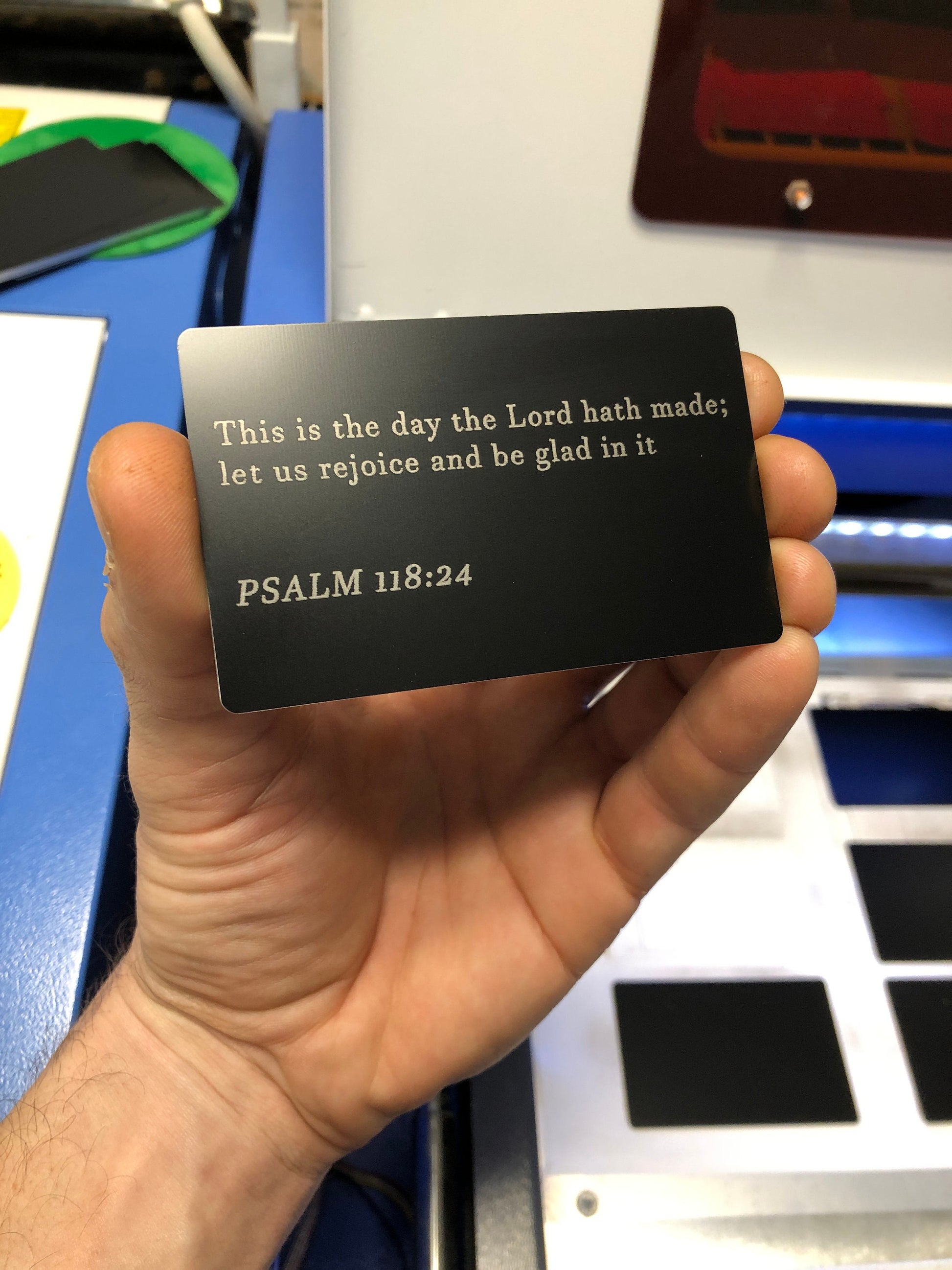 Black/silver metal bible quote placard with Psalm 118:24 text engraved in anodized aluminum