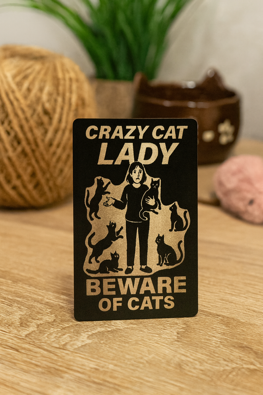 Decorative sign with 'Crazy Cat Lady, Beware of Cats' text and illustrations on a wooden surface.