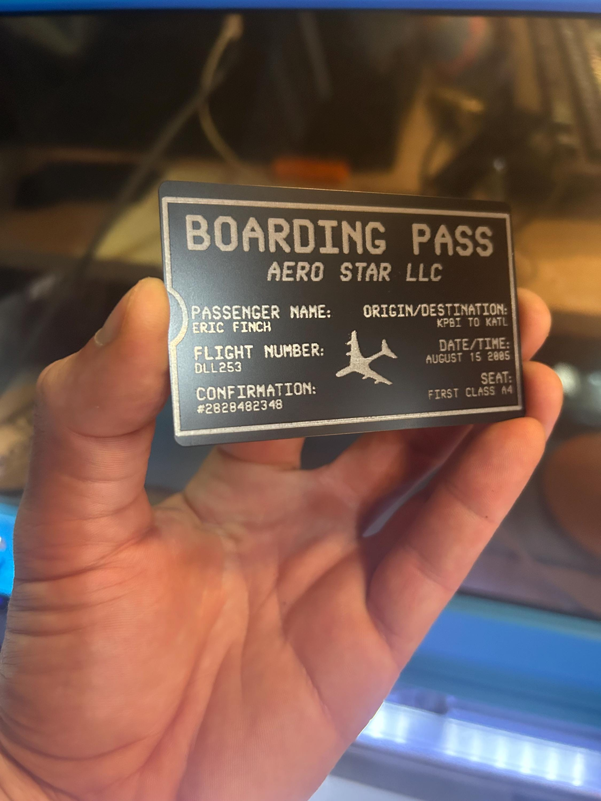Laser engraved personalized metal boarding pass ticket example with customized text and detailed art