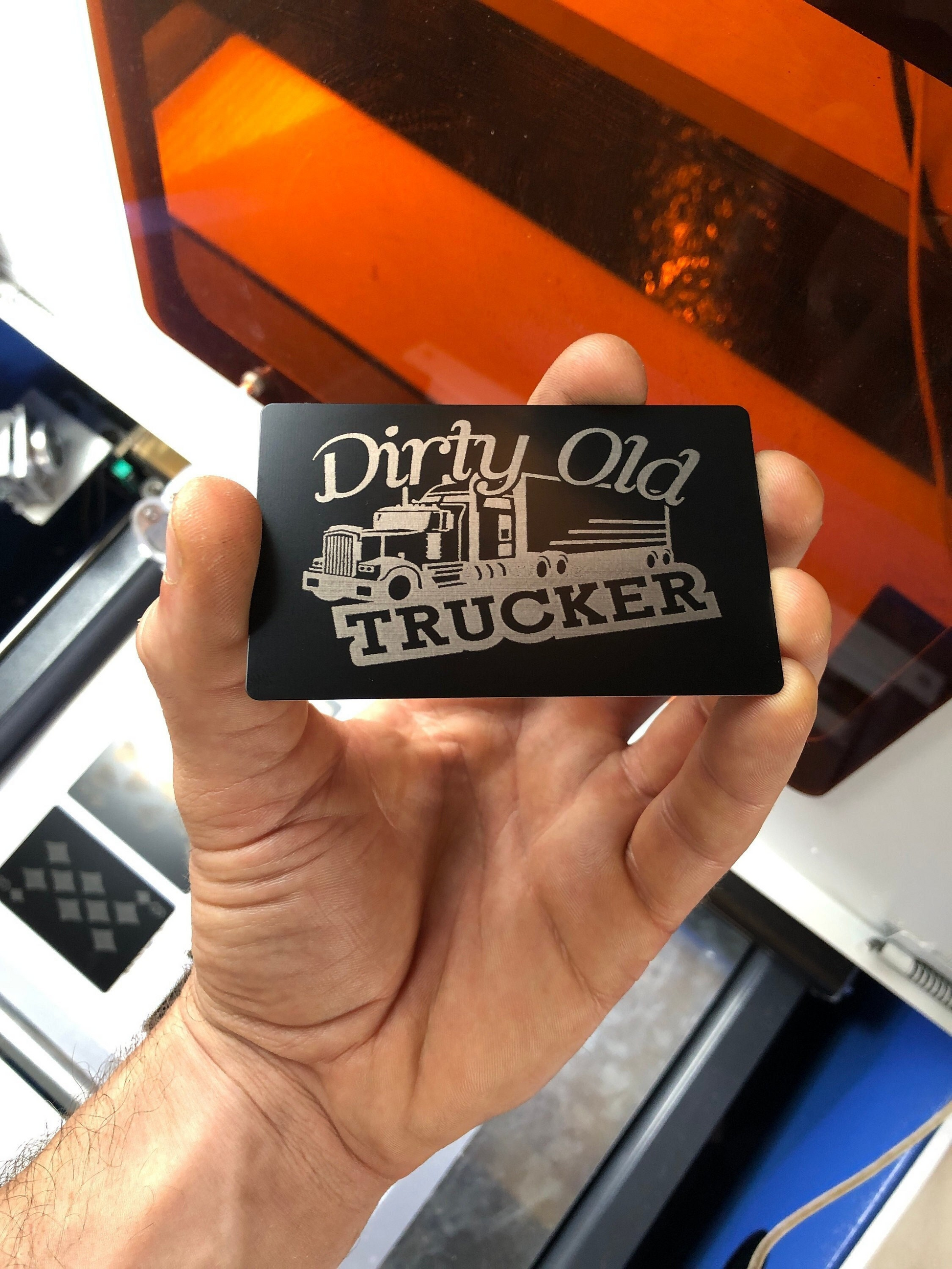 'Dirty Old Trucker' metal gift card with a semi truck graphic