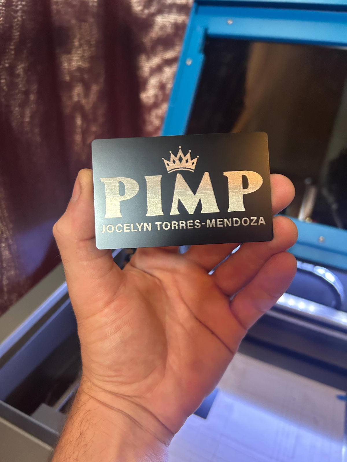 Laser engraved metal keepsake card with 'PIMP' graphic