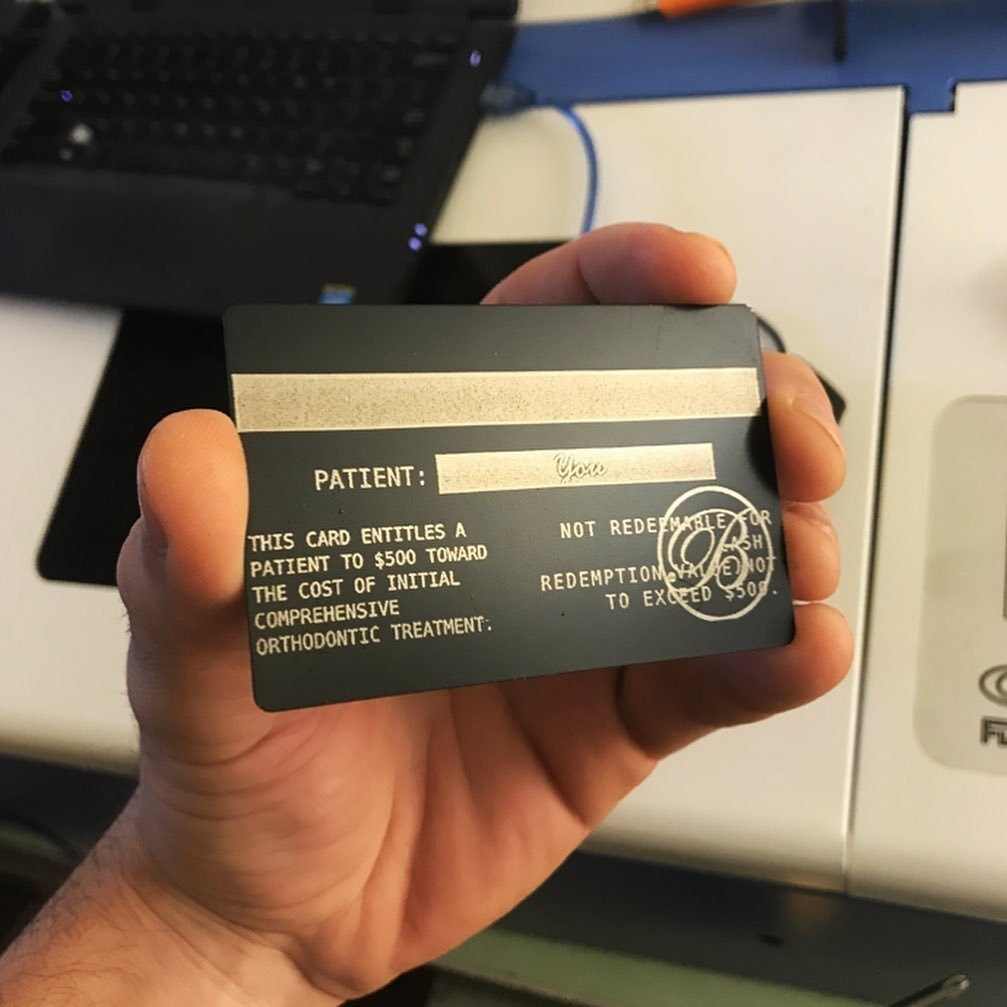 Black and silver card with promotional engraving