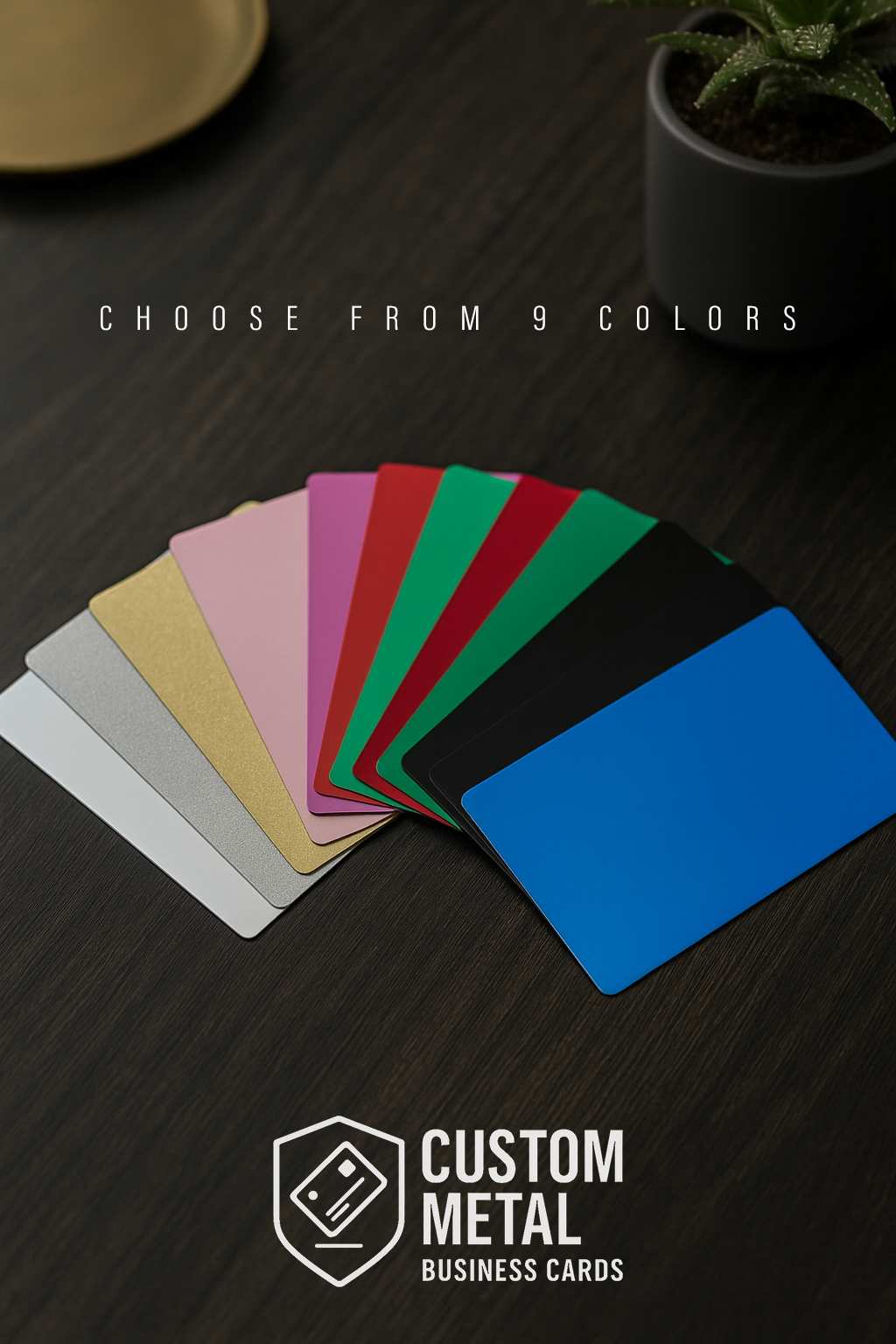 Set of custom metal business cards in 9 color options on a dark surface with 'Custom Metal Business Cards' branding.