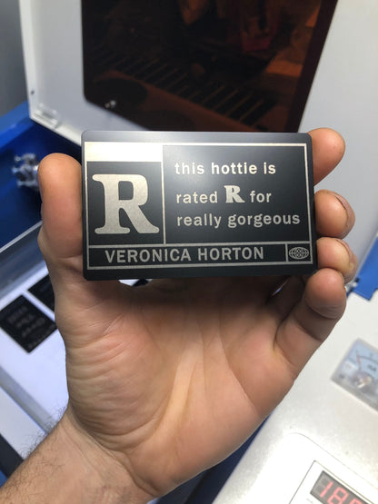 Metal laser engraved keepsake card that reads "This Hottie Is Really Gorgeous"