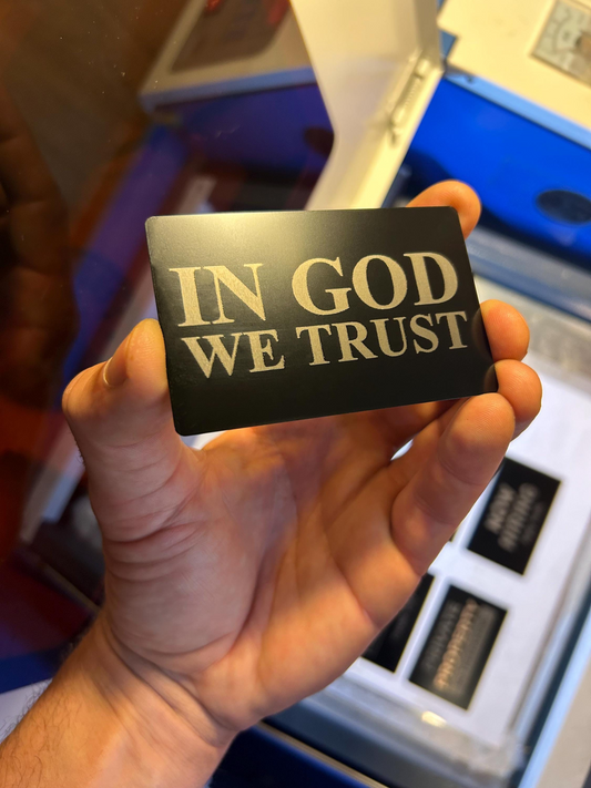 Metal business card with 'IN GOD WE TRUST' engraving