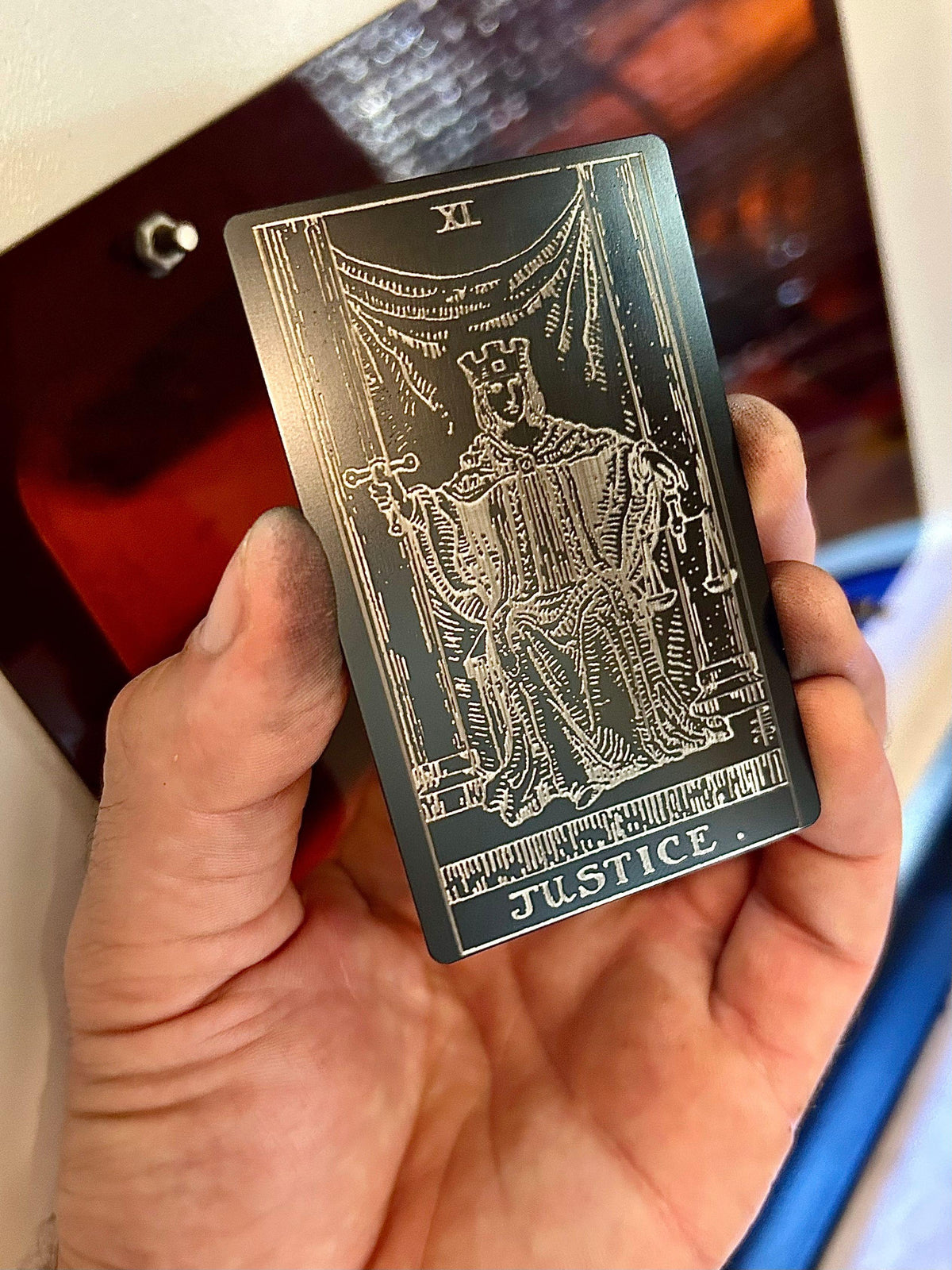 Laser engraved metal tarot card with Justice artwork in black/silver anodized aluminum