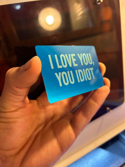 Metal keepsake card with I love you, you idiot typography