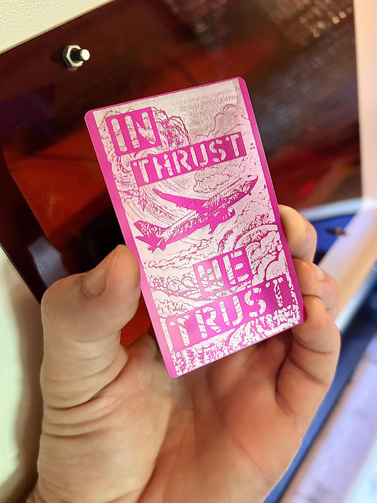 Laser engraved "In Thrust, We Trust" airplane art keepsake in purple/silver anodized aluminum