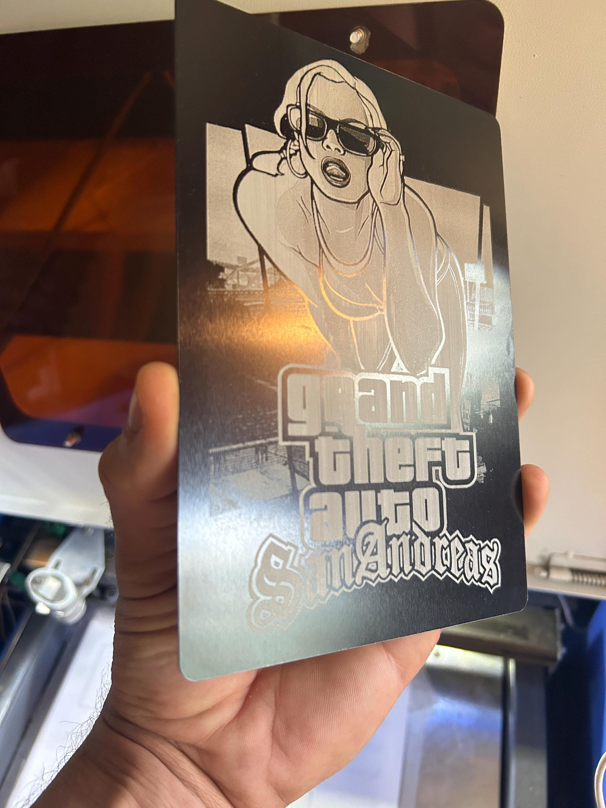 Black / silver laser engraved video game box art collectors display placard any art or text for fan art -- held by a person