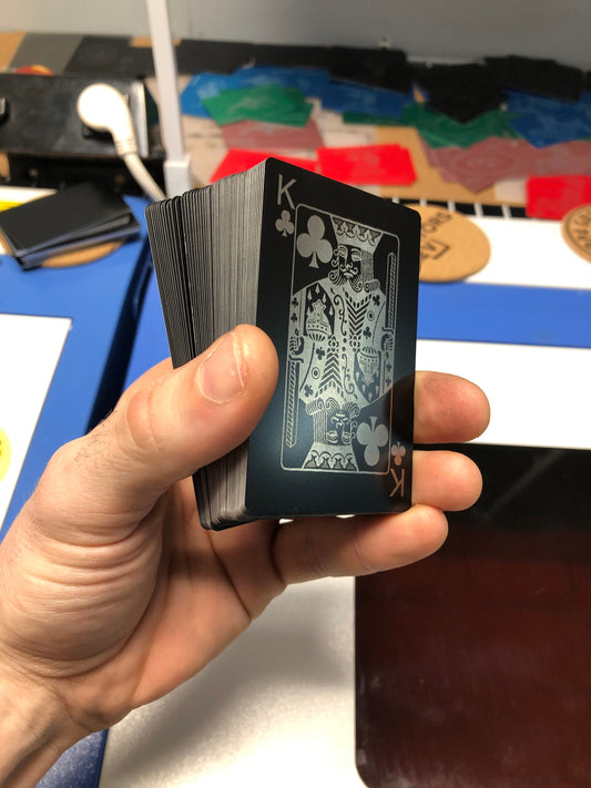 Laser engraved metal poker cards with King of Clubs on top in black/silver