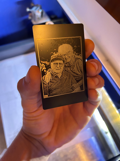 Small engraved metal card with a portrait of elderly couple
