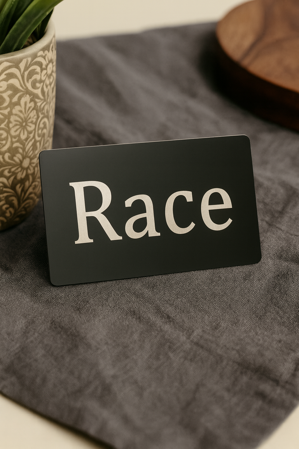 Black metal gag gift card with 'Race' engraved on front