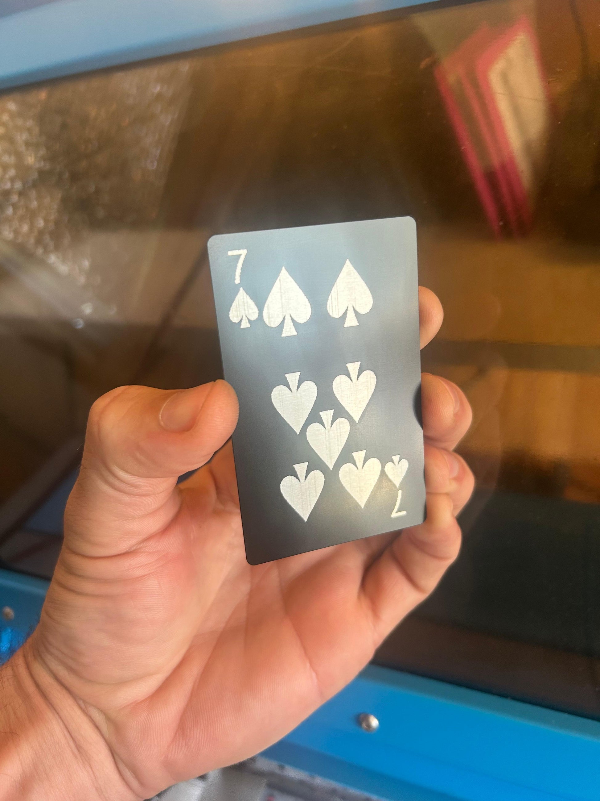 Laser engraved metal 7 of Spades playing card