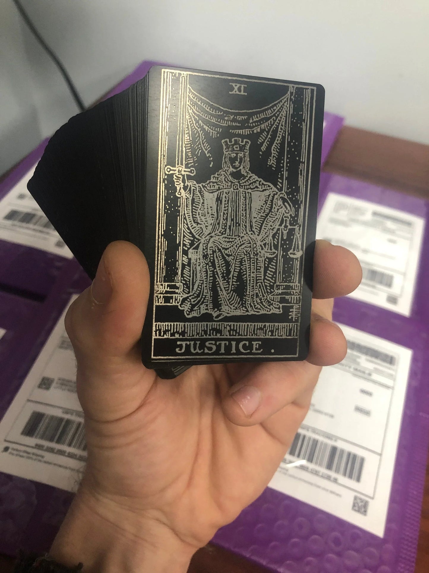 Metal tarot card deck with Justice card on top