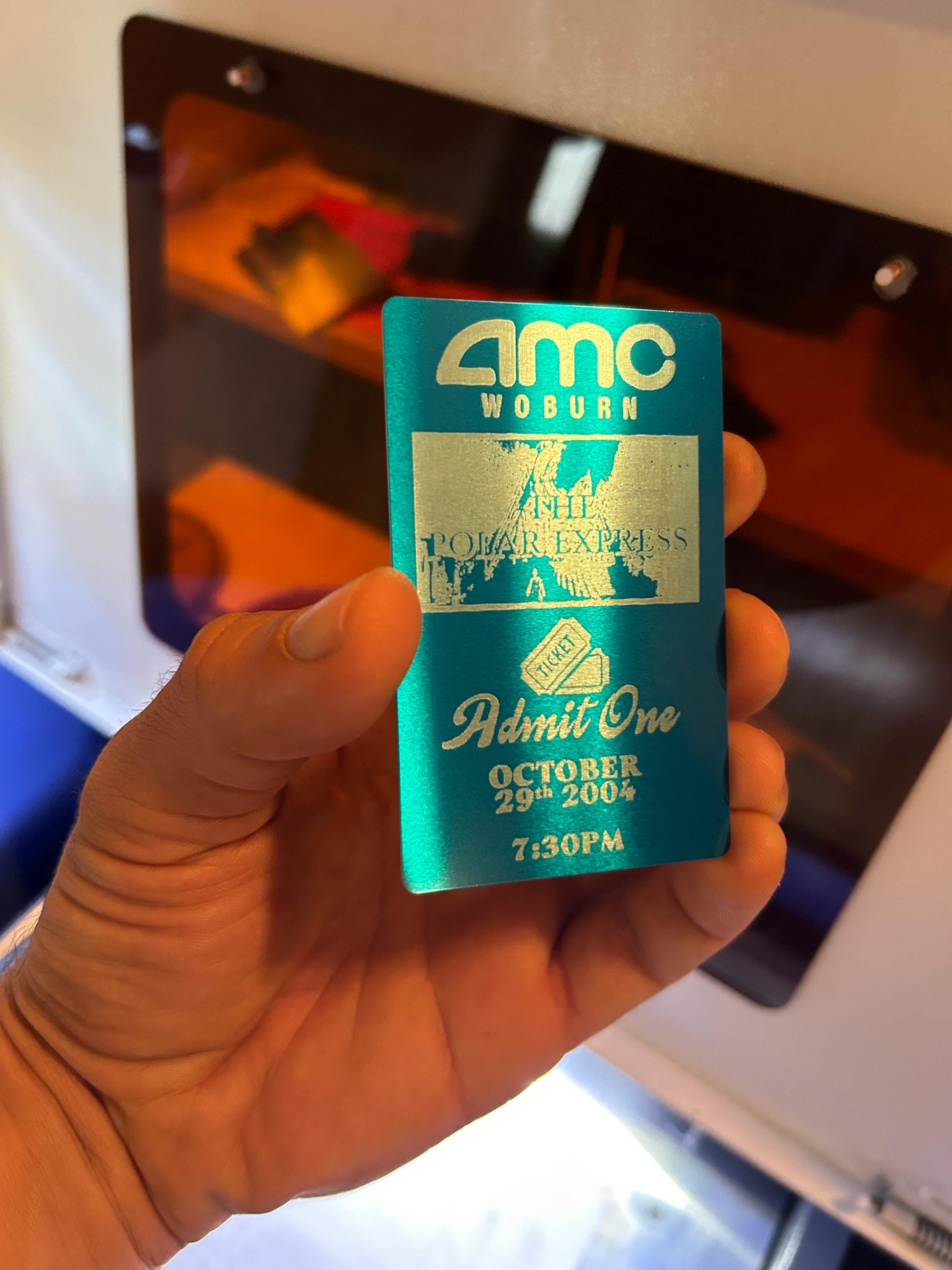 Laser engraved custom metal movie ticket in blue/silver