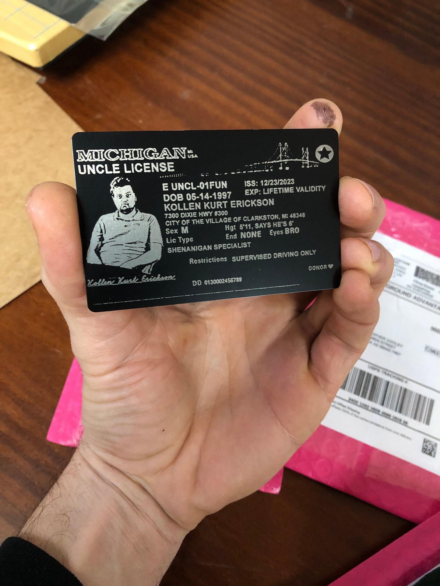 Laser engraved metal business card example with custom "Uncle License" design