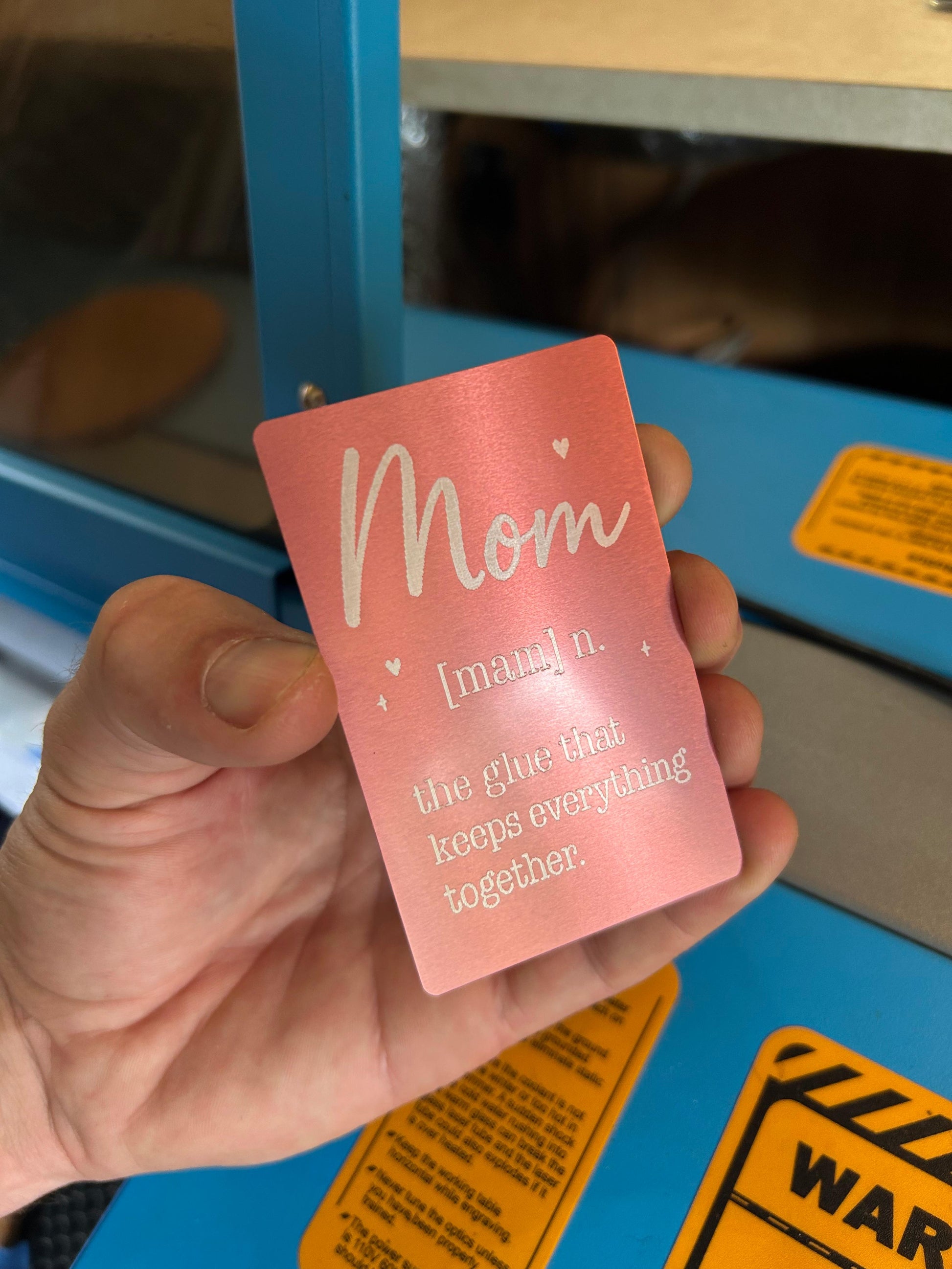Metal keepsake card that reads Mom: The Glue that keeps everything together
