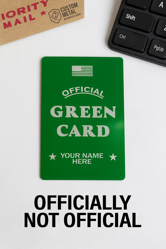 Green card mockup with 'Official Green Card' text on a white surface with keyboard and Priority Mail box.