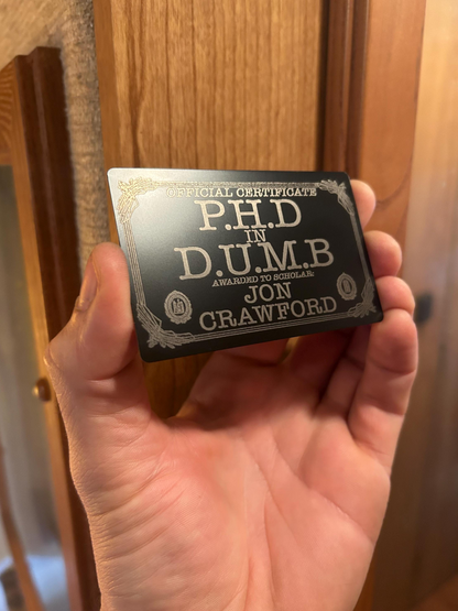 laser engraved metal keepsake sarcastic certificate with text and a decorative border.