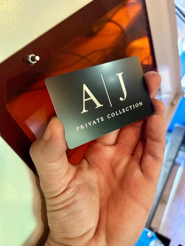 Laser engraved metal business card with private collection engraving in black/silver anodized aluminum