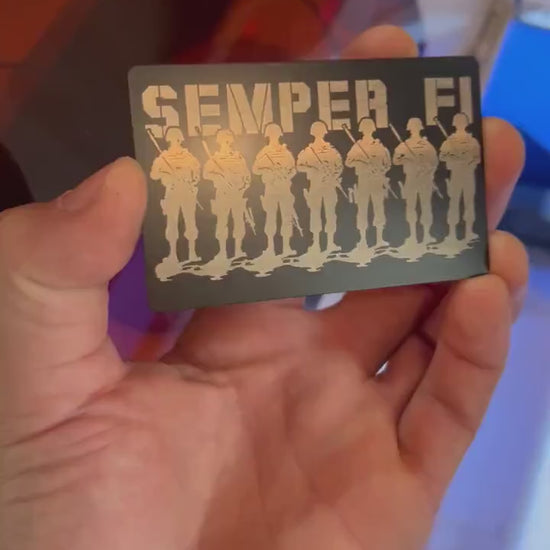 Video of engraved metal wallet card turning under light to show reflective finish of semper fi military platoon artwork