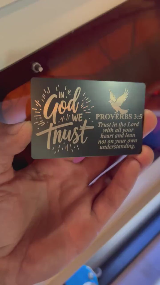 Hand holding In God We Trust laser engraved keepsake gift card with bible verse and dove typographic design