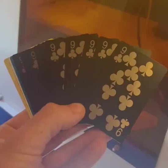 Video of and holding a run of 9 of clubs metal playing cards for a client celebrating 9th birthday party favor gift