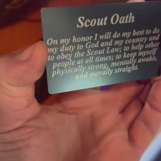 Video of hand holding the metal Scout Oath laser engraved keepsake card, with close up demonstrating text and reflective properties of the commemorative card