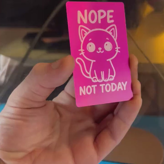 Close-up video of laser engraved metal "Nope Not Today" text and kitten artwork keepsake card rotating to show shine and detail
