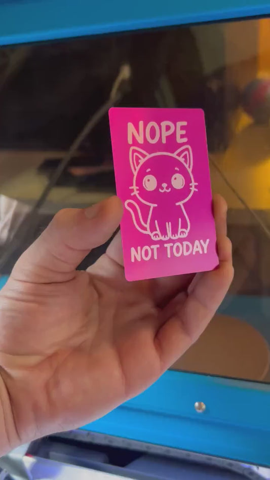 Close-up video of laser engraved metal "Nope Not Today" text and kitten artwork keepsake card rotating to show shine and detail
