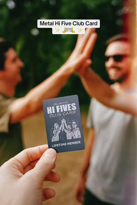 Hand holding a metal hi five club card while two people high five in background